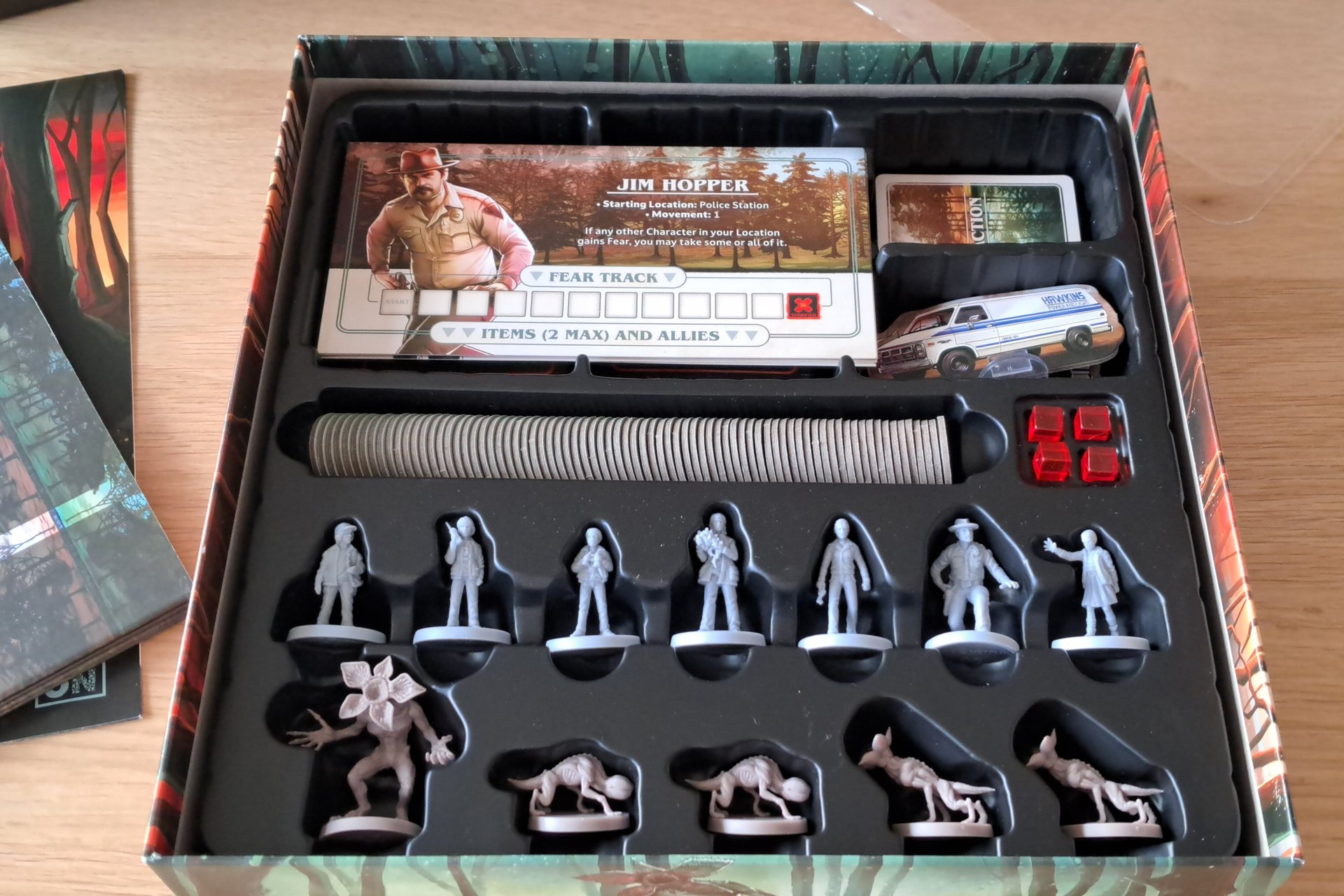 Everything included in the Stranger Things board game box, figures, cards, tokens, and the double sided board