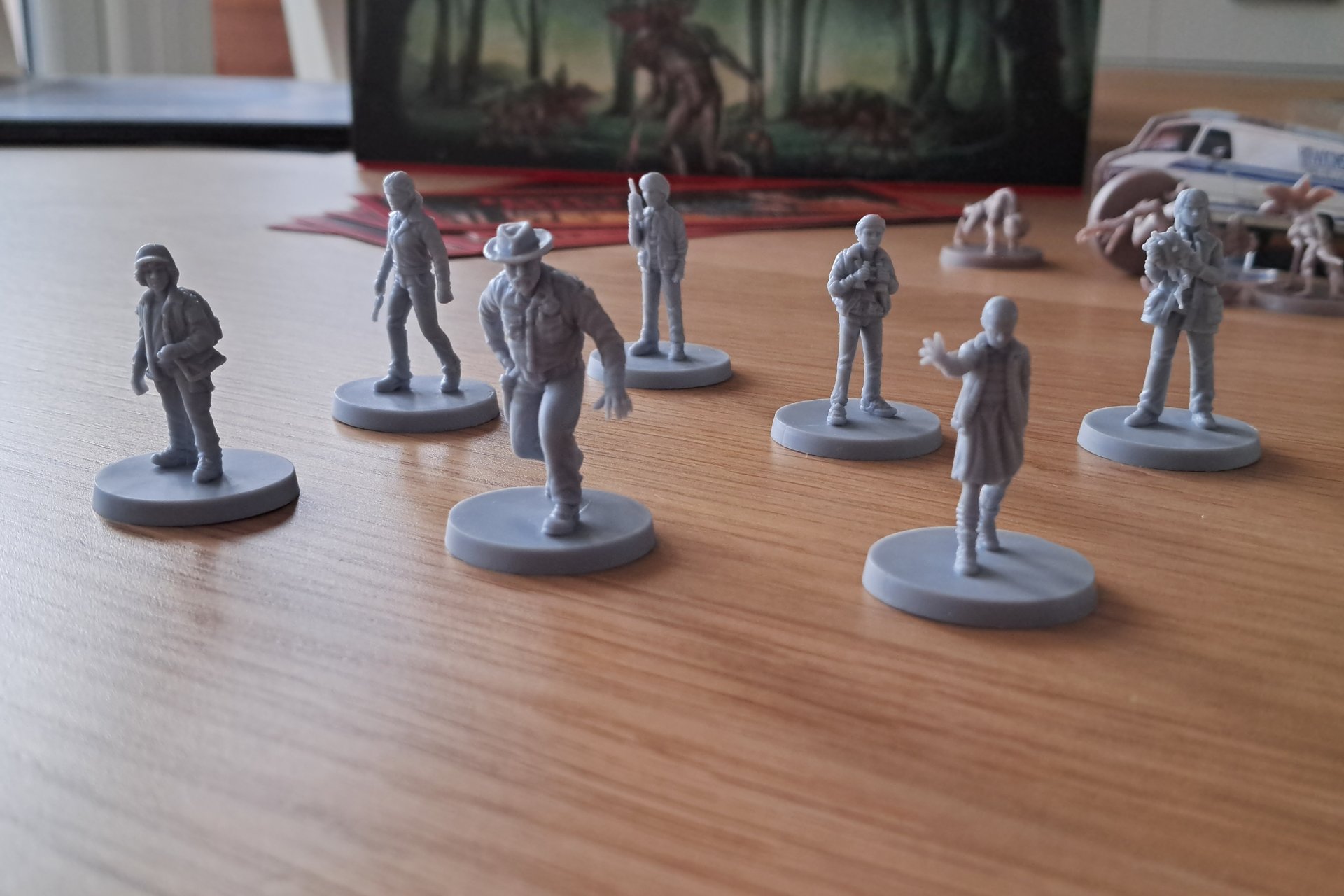 Seven plastic character figures from Stranger Things board game