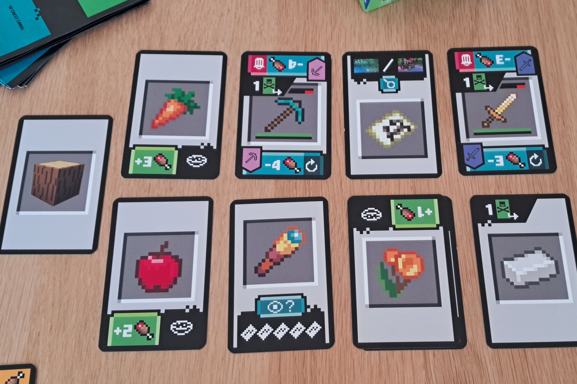 Photo of nine Landscape cards from the Minecraft Explorers card game, with the reverse side showing icons of food and tools