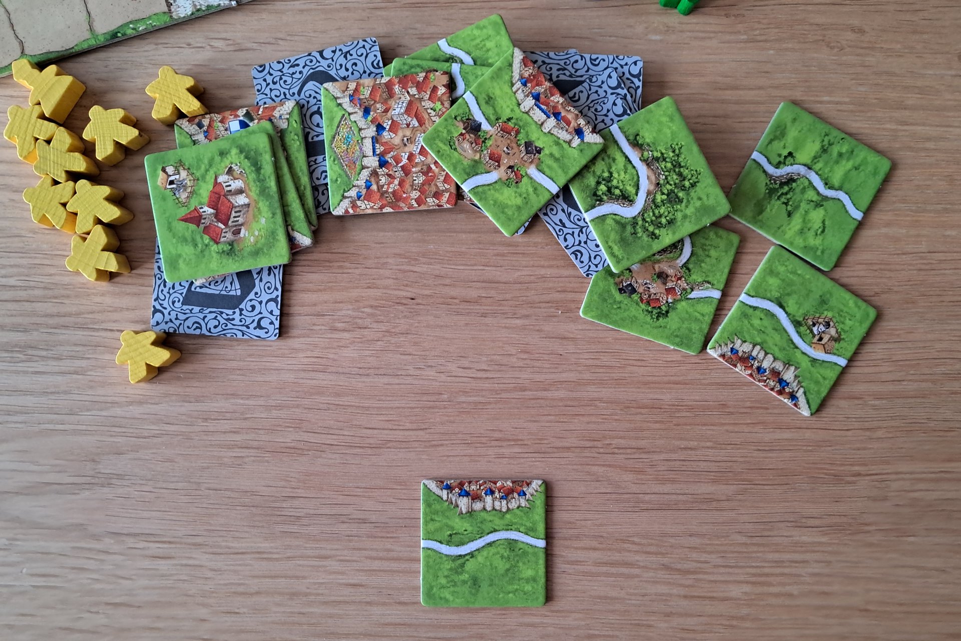 Carcassonne tiles face up, showing roads, cities, fields, and monasteries