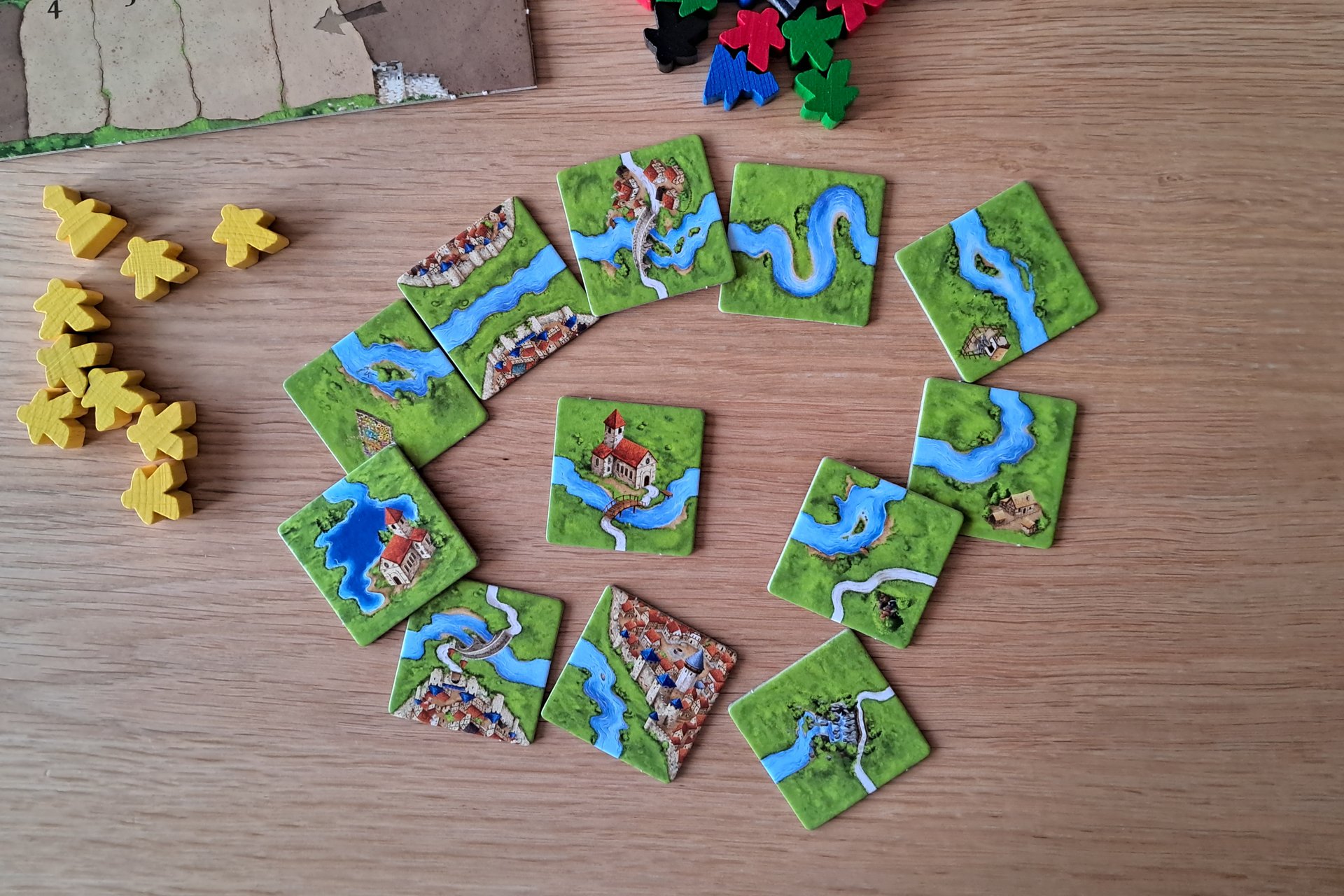Carcassonne River expansion tiles laid out on the table