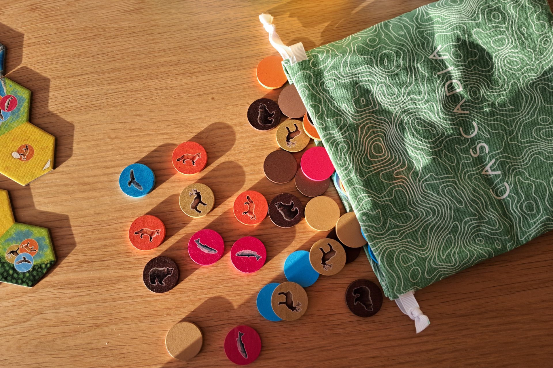 Close up photo with the Wildlife Tokens (Bears, Elks, Salmons, Hawks and Foxes)