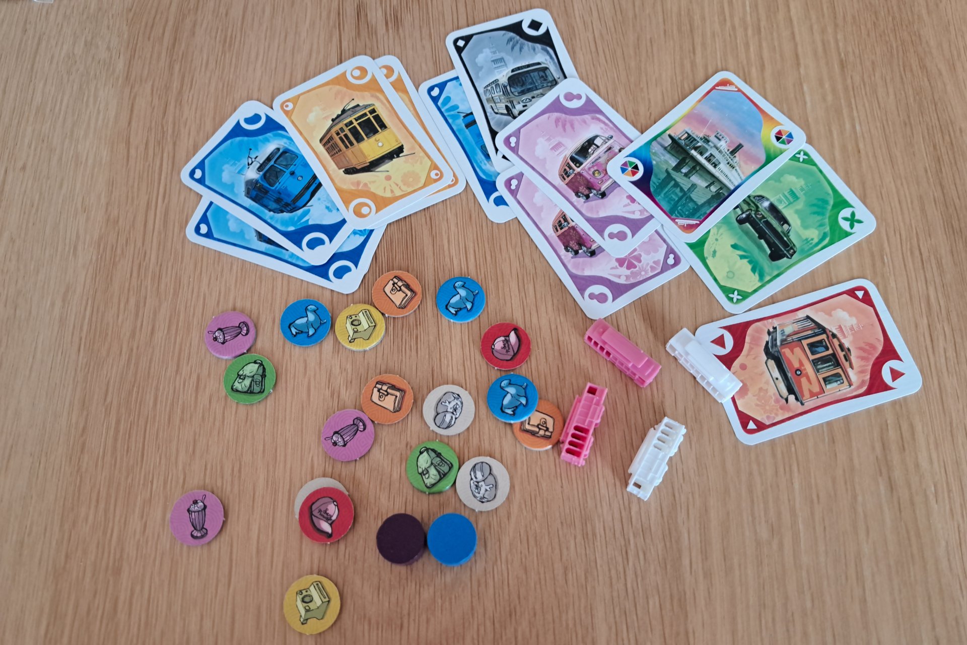 Ticket to Ride San Francisco components displayed on the table, including transport cards, tram pieces, and souvenir tokens.