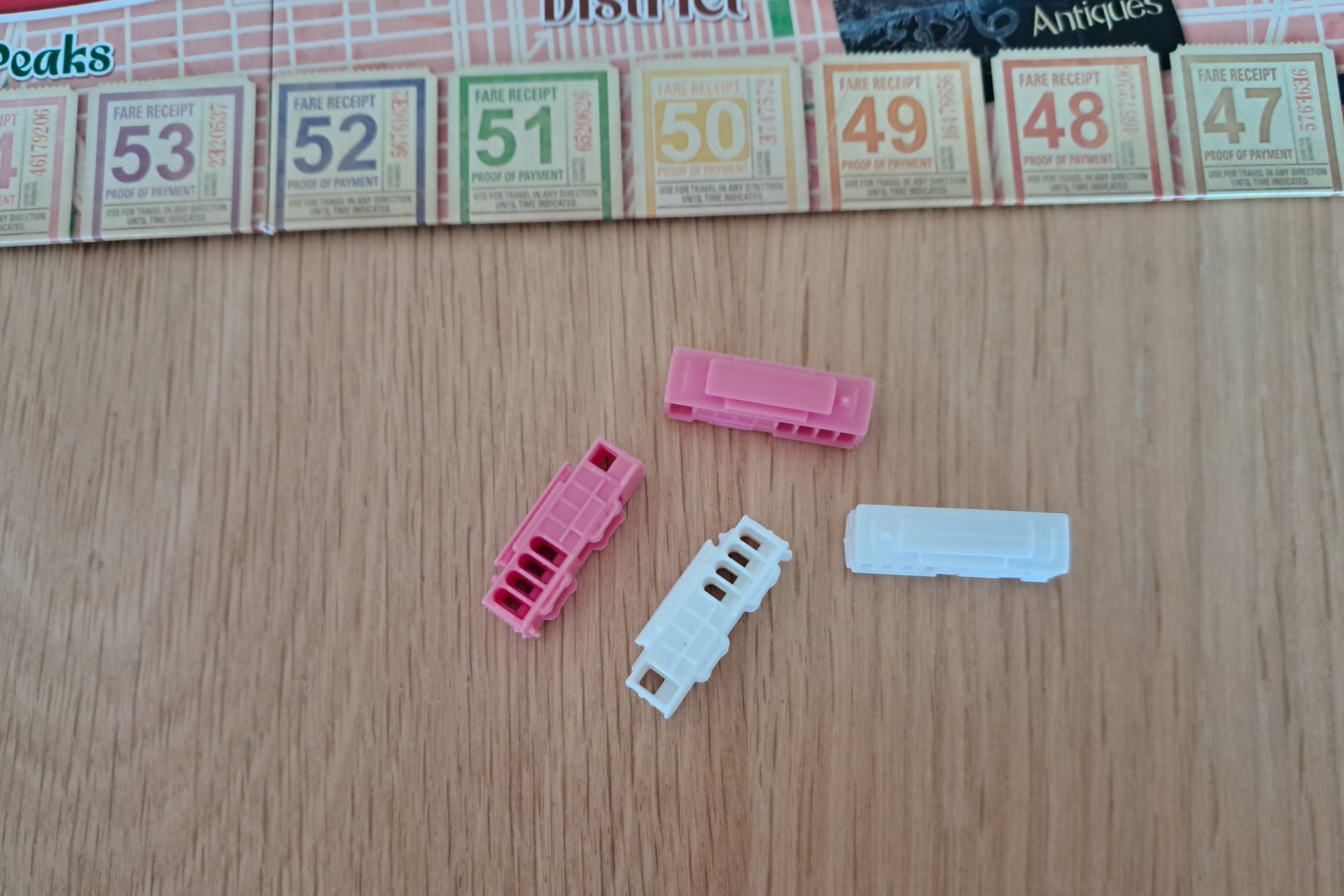 Close up photo of two pink and two white trams.
