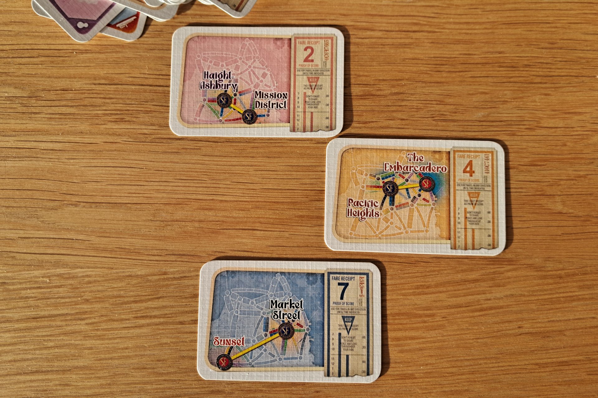 A set of three destination cards from Ticket to Ride San Francisco during gameplay.