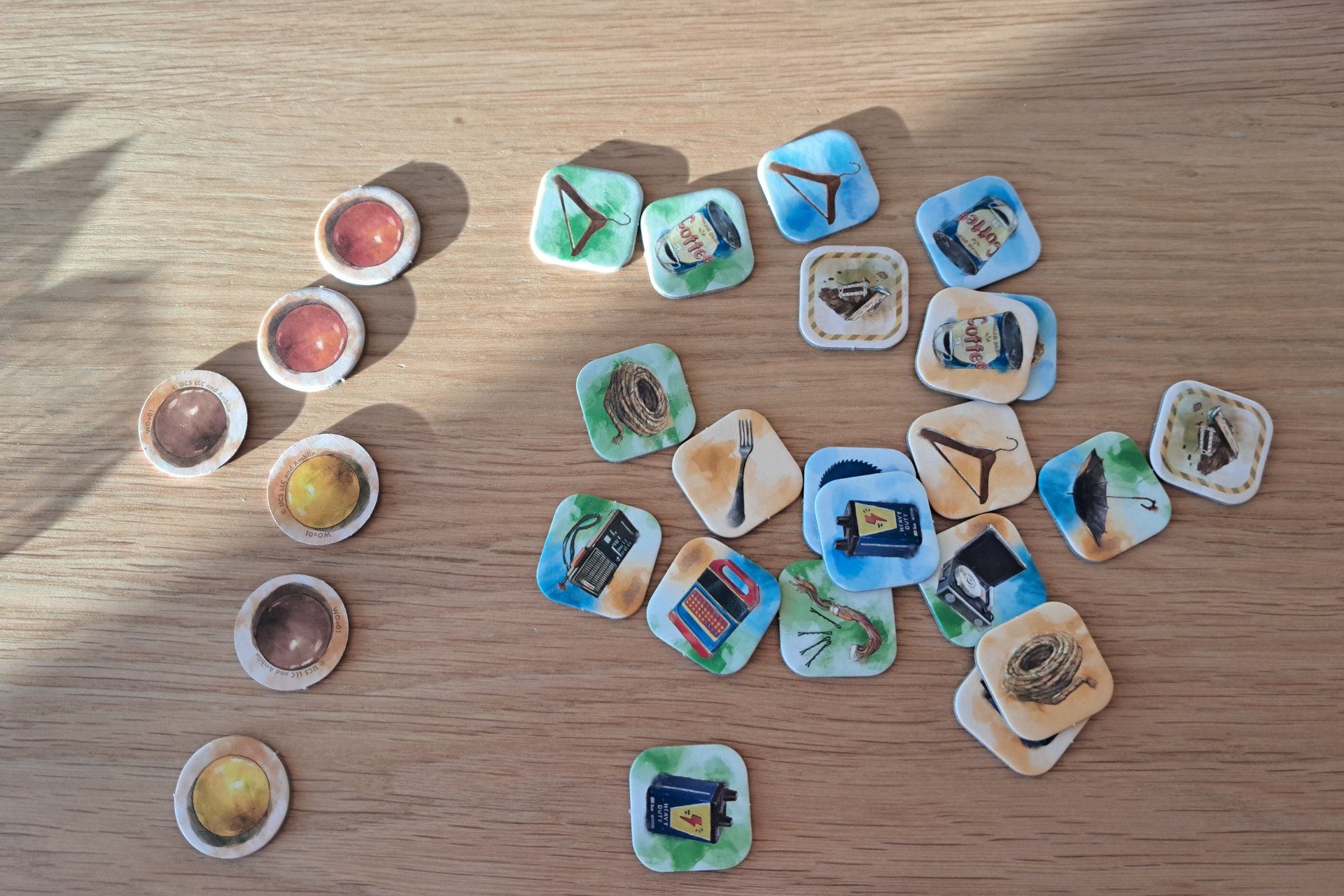 Close up image of the item tokens and candy tokens from the E.T. The Extra Terrestrial Light Years From Home board game.