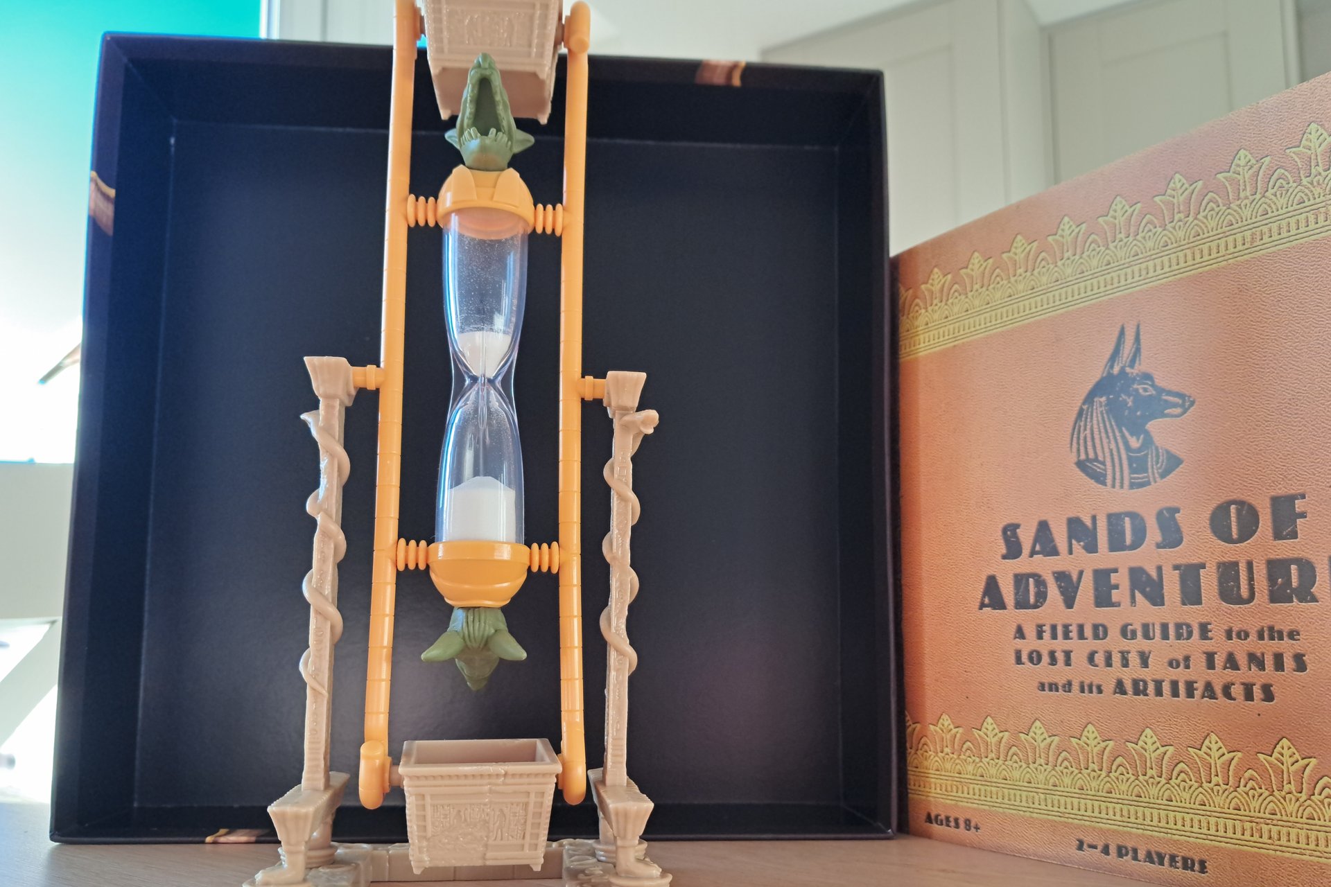 Close up of the sand hourglass timer from the Indiana Jones Sands of Adventure board game.