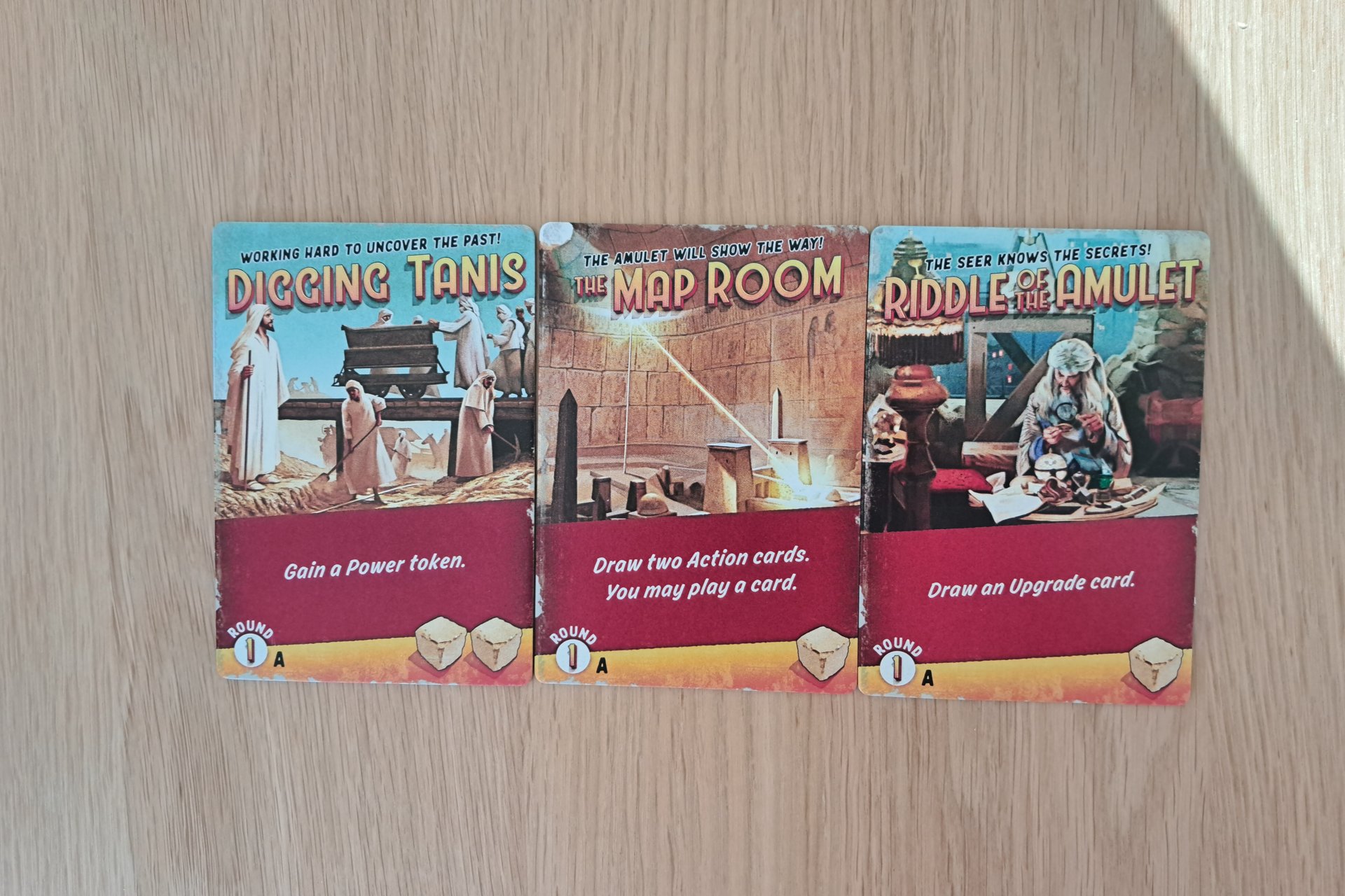 Three adventure tiles from Round 1, Phase A of the Indiana Jones Sands of Adventure board game.