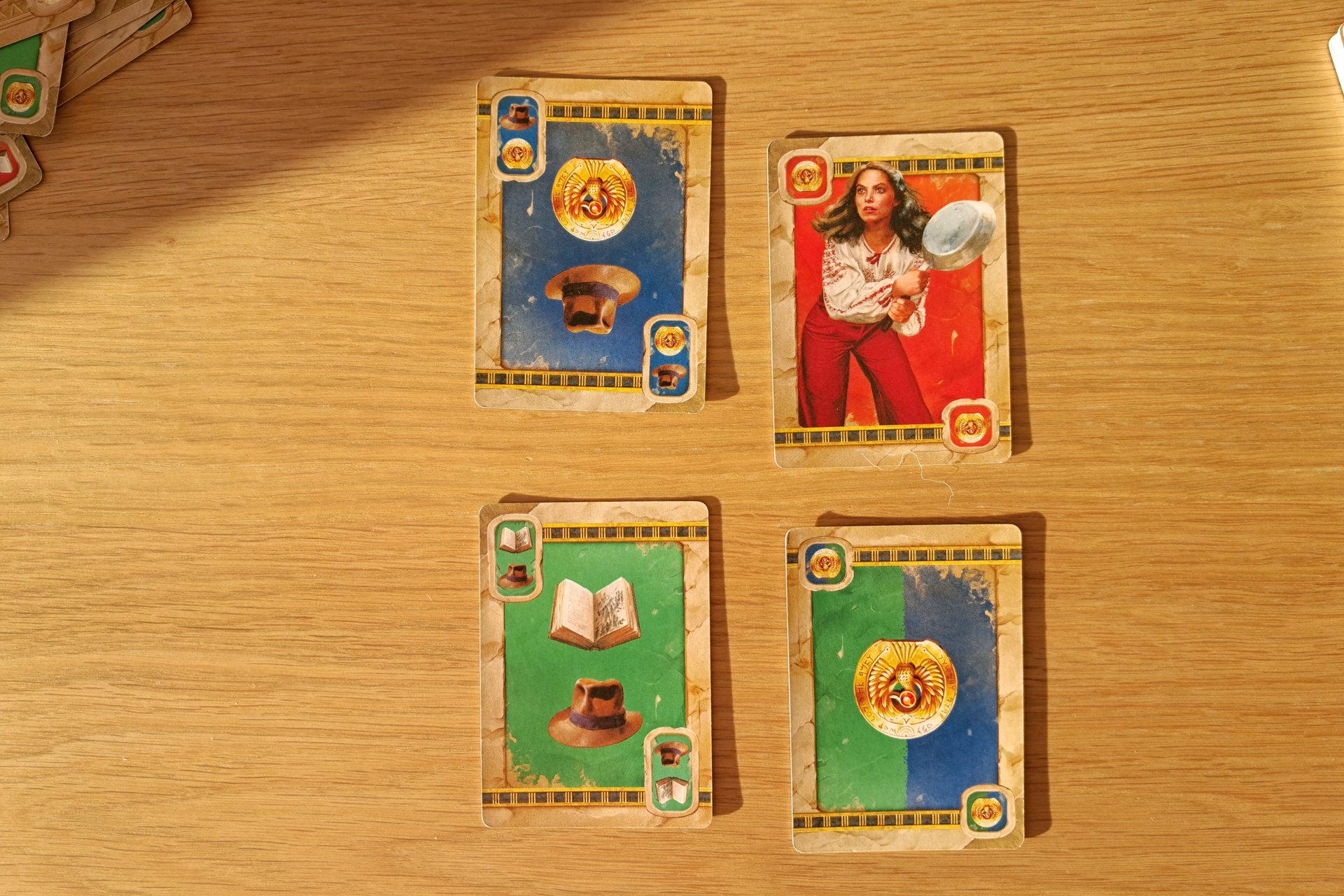 Four upgrade cards from the Indiana Jones Sands of Adventure board game.