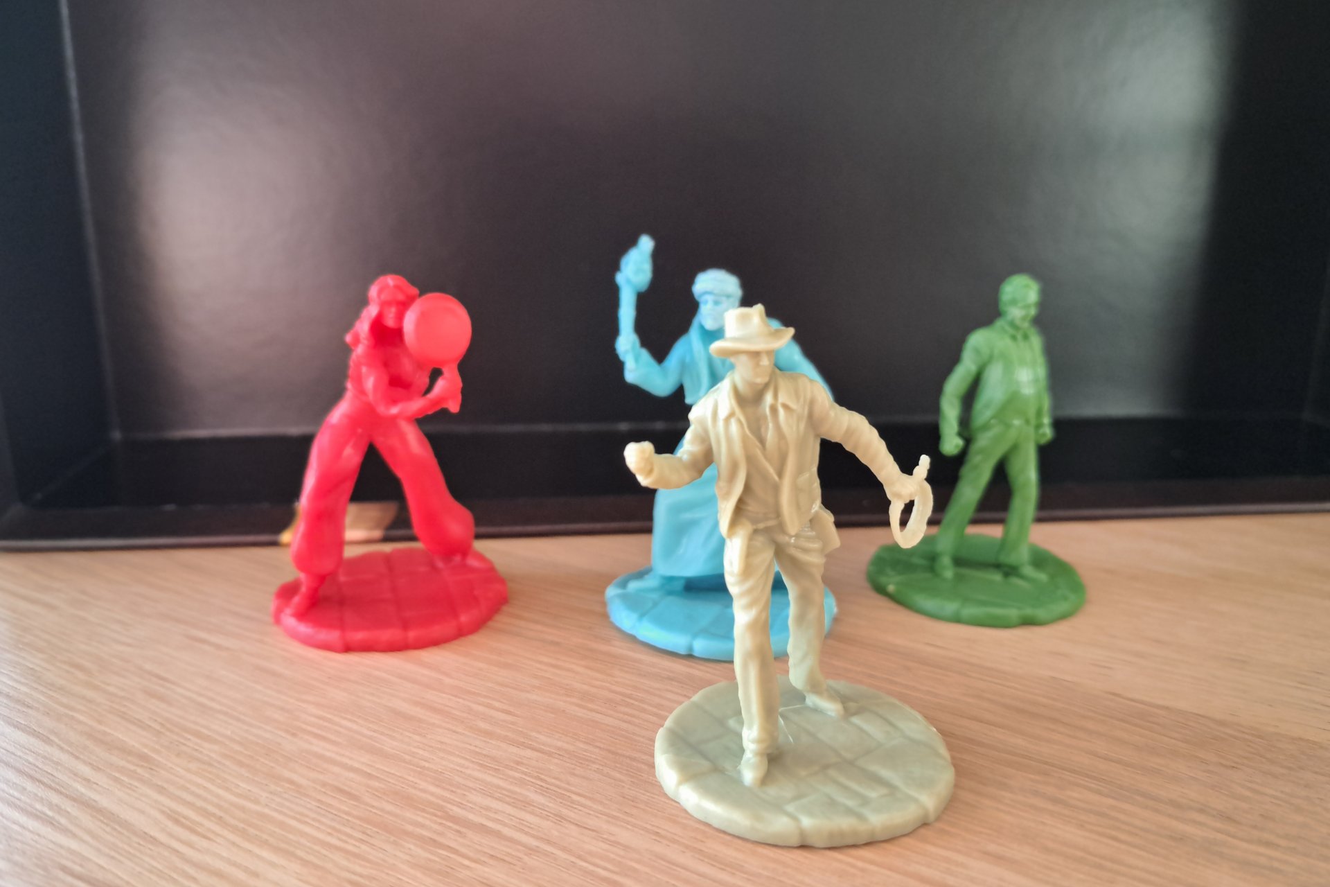 Four plastic character figures from the Indiana Jones Sands of Adventure board game.